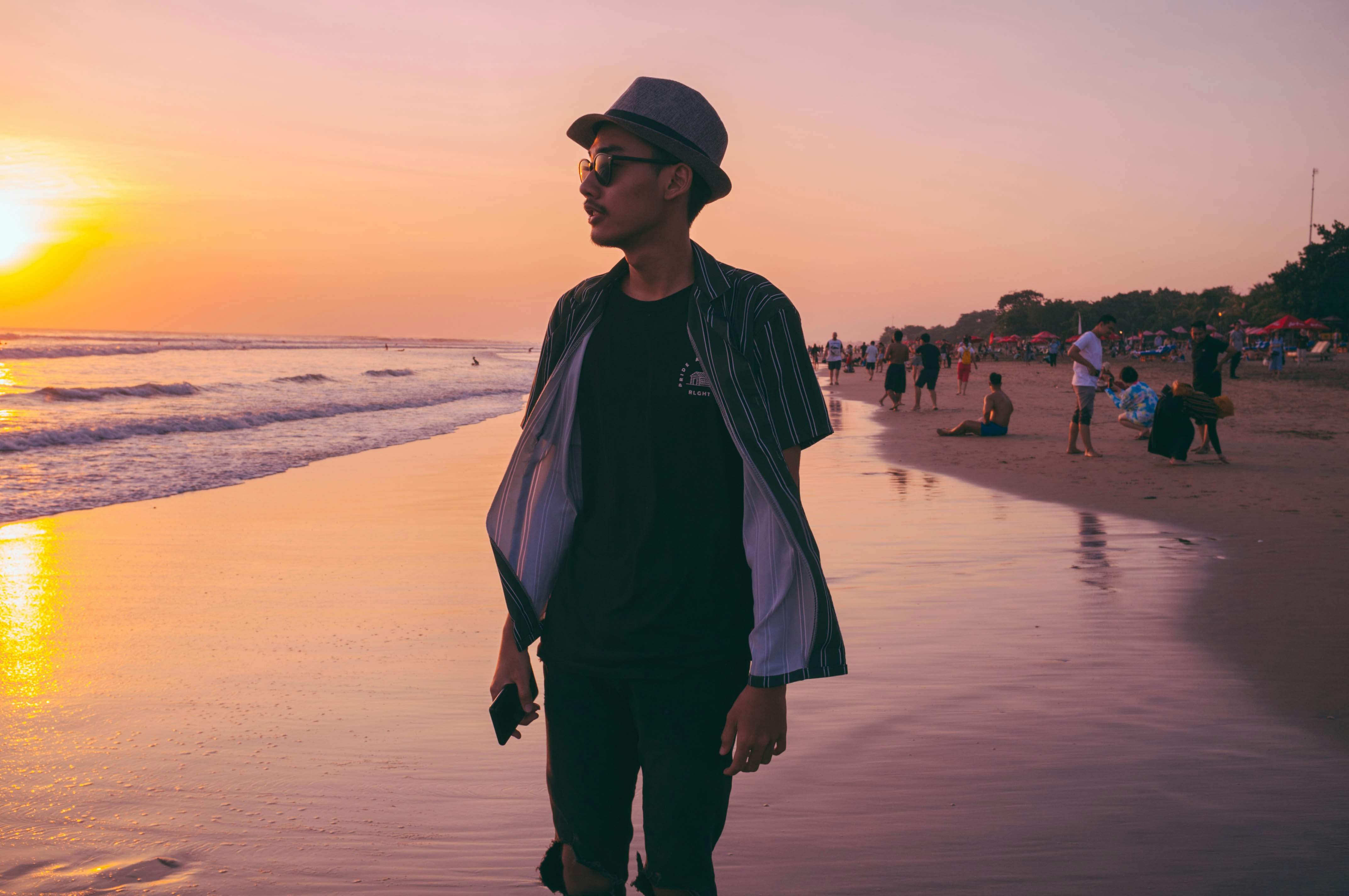 man standing beside seashore